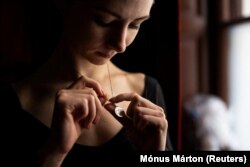 A necklace with a map of Ukraine reminds Muromtseva of home.