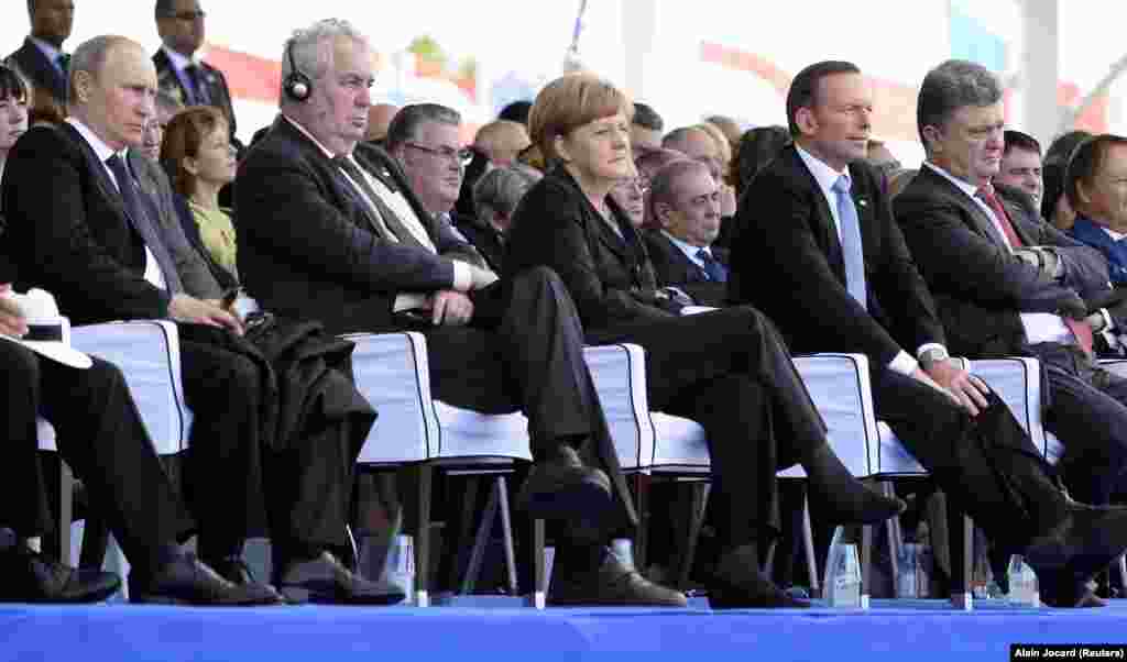 The 2014 commemoration was attended by Russian President Vladimir Putin (left), Czech President Milos Zeman (second from left), German Chancellor Angela Merkel (center), Australian Prime Minister Tony Abbott (second from right), and Ukrainian President-elect Petro Poroshenko.