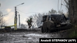 A Ukrainian soldier runs for cover from shelling across a street in the frontline town of Bakhmut on April 23.