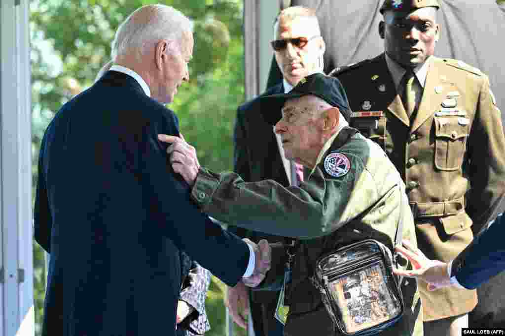 Biden meets with another veteran during the ceremony. 
