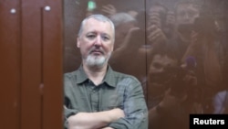 Igor Girkin sits behind a glass wall of an enclosure for defendants before a court hearing in Moscow on July 21.