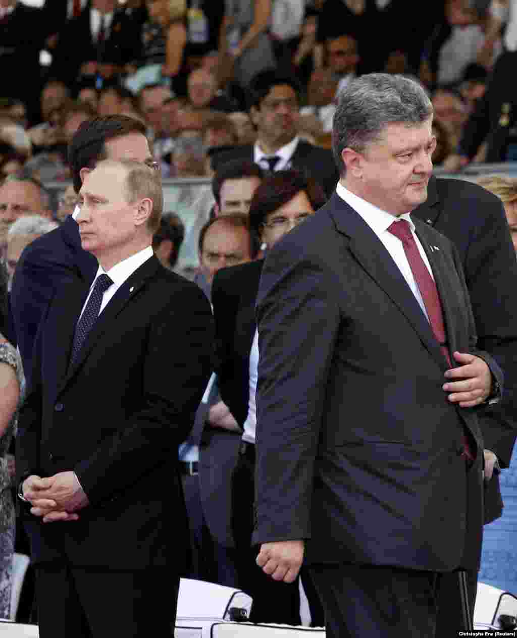 During the 70th anniversary in 2014, Ukraine's president-elect, Petro Poroshenko (right), walks past Russian President Vladimir Putin without acknowledging his presence amid tensions over Russia's illegal annexation of Crimea, which had occurred three months earlier. In an attempt to resolve the crisis sparked by Russia-backed separatists in eastern Ukraine and Moscow's annexation of Crimea, then-French President Francois Hollande had invited his Russian and Ukrainian counterparts in an effort to reduce tensions over the conflict.