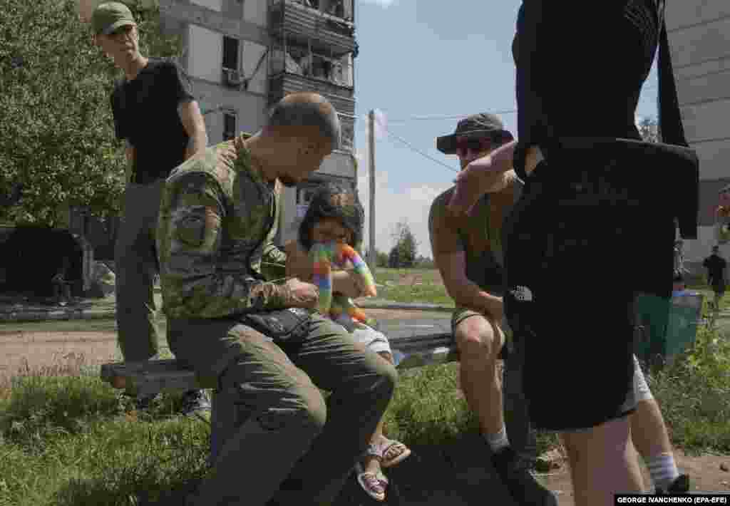 A young girl is comforted at the scene. 