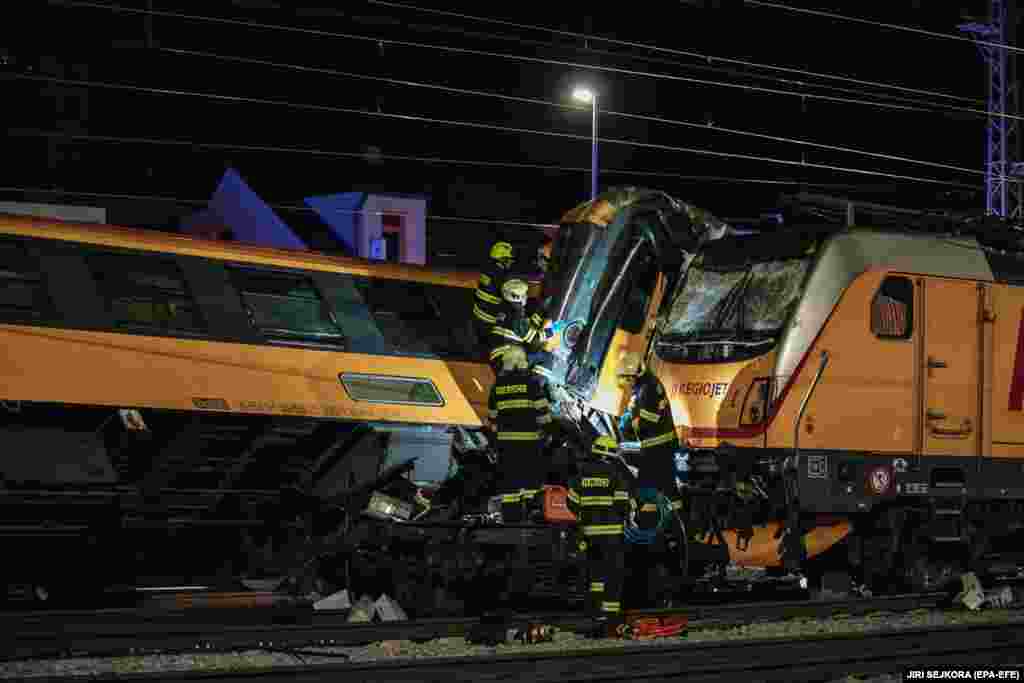 Rescue workers at the scene of a train crash in the city of Pardubice on June 5. Four people died, including two Ukrainians, and at least 20 people suffered light injuries in the crash, which occurred after 11 p.m. along the country's main rail corridor from Prague to the east, Interior Minister Vit Rakusan said.