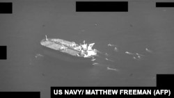 A U.S. Navy video shows fast-attack craft from Iran's Islamic Revolutionary Guards Corps swarming an oil tanker as it transits the Strait of Hormuz on May 3.