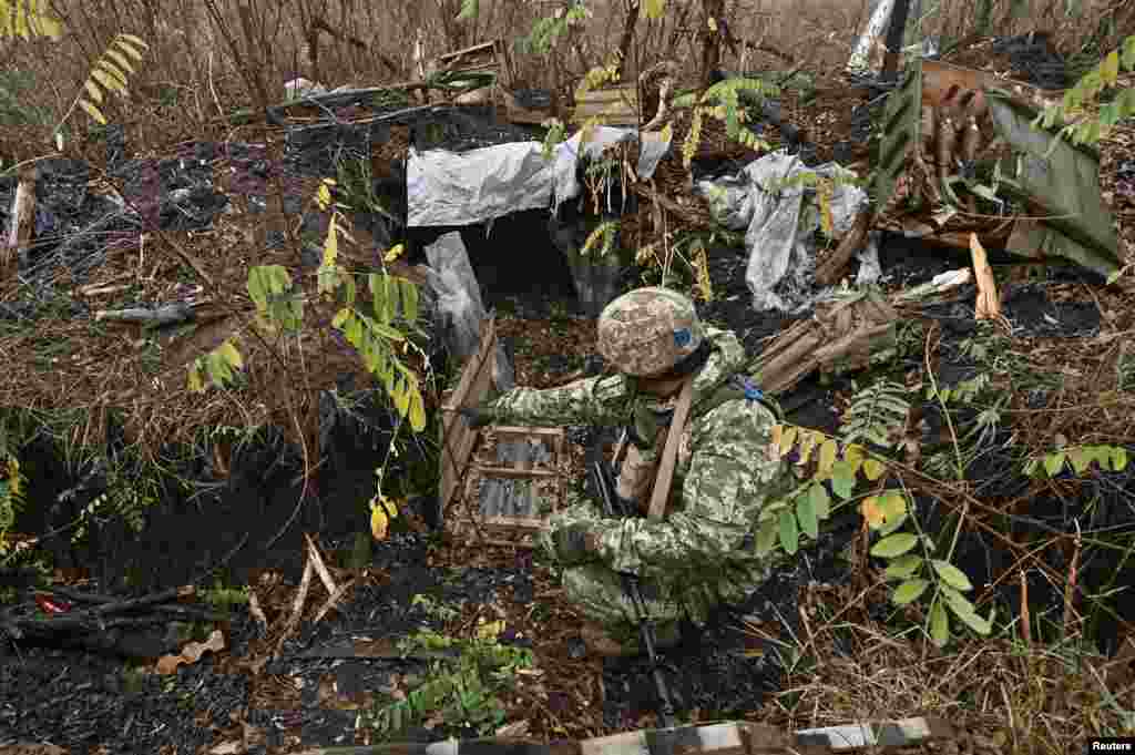 A Ukrainian serviceman inspects ammunition that was left behind by Russian soldiers. Kyiv's troops were able to liberate Robotyne a few months later.