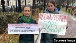Women whose husbands have been mobilized to fight in Ukraine protest for them to be returned home, in Moscow on November 7.