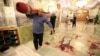 Workers clean up the scene following an armed attack at the Shah Cheragh mausoleum in the Iranian city of Shiraz on October 26, 2022. 