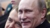 Russia -- President Dmitry Medvedev (L) and Prime Minister Vladimir Putin speak as they watch a military parade on Red Square on Victory Day in Moscow, 09May2011
