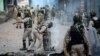 Indian security forces clear road blockades following clashes with Kashmiri protestors on August 29.