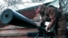 A Russian paratrooper prepares his sniper rifle at an undisclosed location in Ukraine on April 8. The Freedom House report singled out Russia and Azerbaijan for their "wars of aggression."