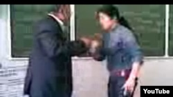 A student purported to be the daughter of an Uzbek prosecutor beats and humiliates a teacher at a university in Uzbekistan.