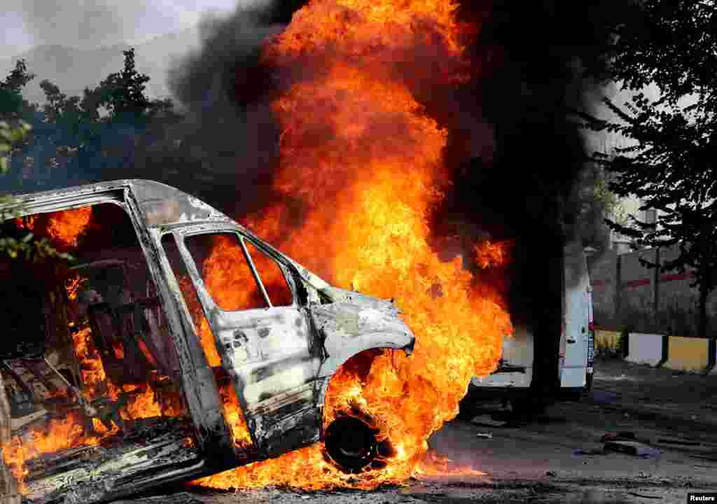 A minibus burns near the compound outside Bishkek where former Kyrgyz President Almazbek Atambaev was holed up. 