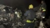 Ukrainian Emergency Service personnel work at the site of a Russian air strike in Dnipro, eastern Ukraine, early on October 26.
