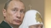 Russia -- President Vladimir Putin and Patriarch Aleksy II at a memorial service for the victims of Soviet-era political repression, in Butovo, 30Oct2007