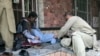 People attend to a man injured in a blast in the Afghanistan's Balkh Province on March 11.