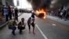 An Atlanta Police Department vehicle burns as people pose for a photo during a demonstration against police violence on May 29.