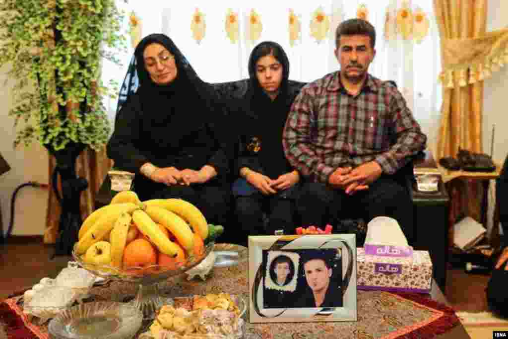 The parents and sister of the victim, Abdollah Hosseinzadeh, at their home. The family had lost another member, their 11-year-old son, in a motorbike accident.