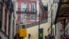 (FILES) A man takes pictures of the Elevador da Gloria (Gloria funicular) in Lisbon on November 8, 2023.