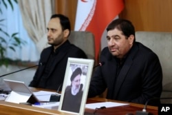 Iran's interim president, Mohammad Mokhber (right), leads a cabinet meeting in Tehran on May 20.