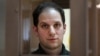 U.S. journalist Evan Gershkovich, arrested on espionage charges, waits in a defendants' cage before a hearing to consider an appeal on his extended pretrial detention, at the Moscow City Court in Moscow on February 20.