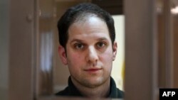 U.S. journalist Evan Gershkovich, arrested on espionage charges, waits in a defendants' cage before a hearing to consider an appeal on his extended pretrial detention, at the Moscow City Court in Moscow on February 20.