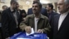 Iran's new election law is seen by some as the outcome of a power struggle between President Mahmud Ahmadinejad (center) and Supreme Leader Ayatollah Ali Khamenei.