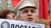Russia -- The day of people's anger (rage) in Moscow, meeting. A man hold newspaper with "Had have enough" (being got at) title, protest, 25Oct2008